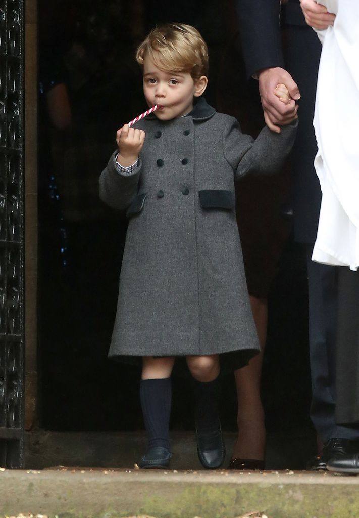 Prince George of Cambridge licks a candy cane at Church on Christmas Day on December 25, 2016 in Bucklebury, Berkshire.
